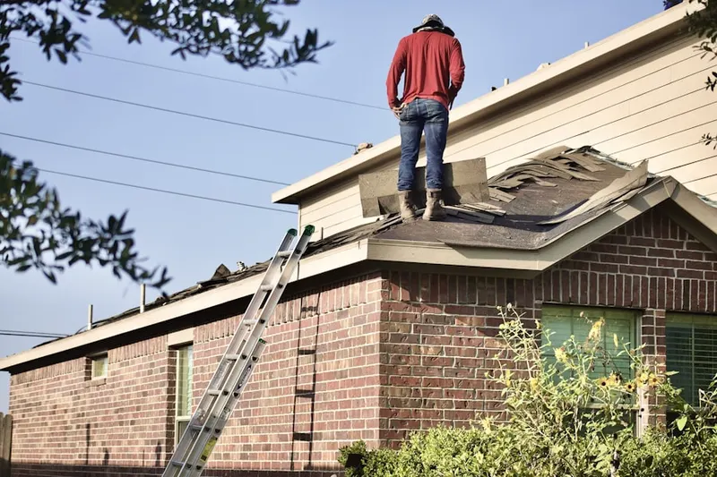Professional roofer working on a residential roof in Rangeline